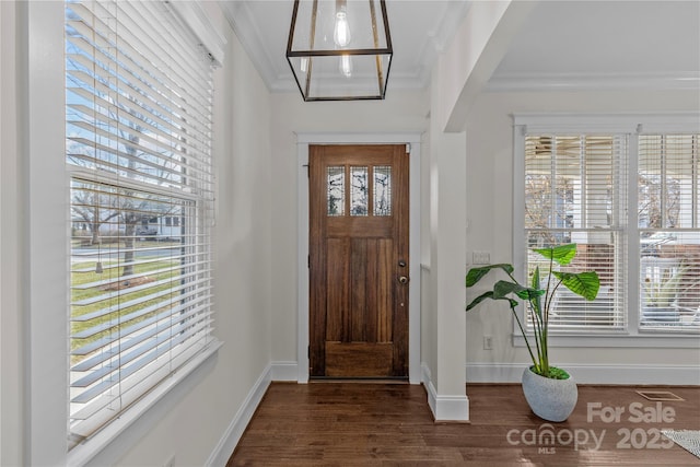 foyer featuring dark wood-type flooring and ornamental molding