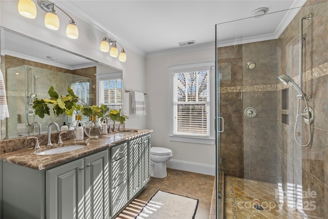 bathroom featuring vanity, crown molding, and a healthy amount of sunlight