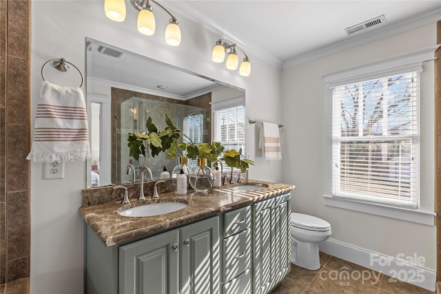 bathroom featuring a shower with door, vanity, ornamental molding, tile patterned floors, and toilet