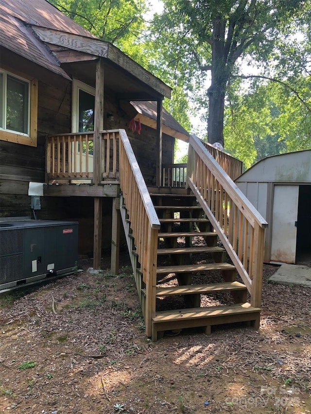 wooden terrace featuring a storage shed and central air condition unit