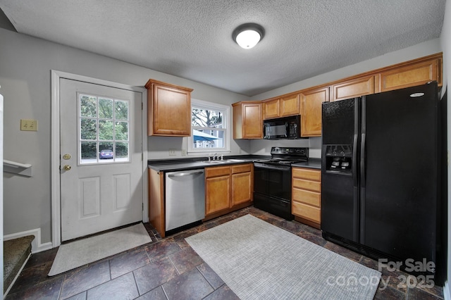 kitchen with sink, black appliances, and a textured ceiling