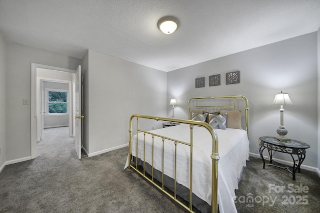 carpeted bedroom featuring a textured ceiling