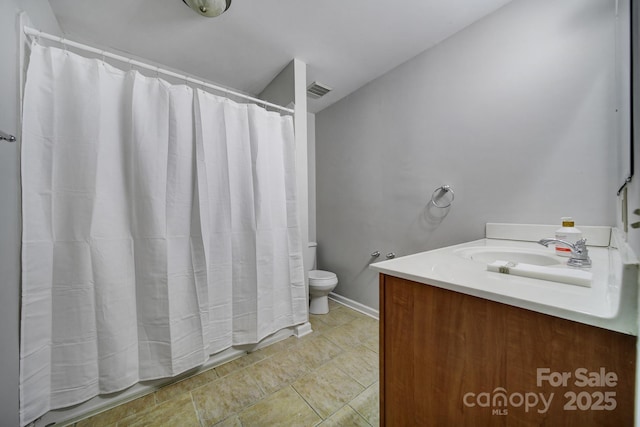 bathroom featuring toilet and vanity