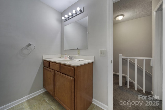 bathroom with a textured ceiling and vanity