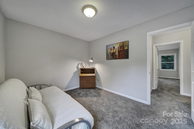 sitting room featuring a textured ceiling and dark colored carpet