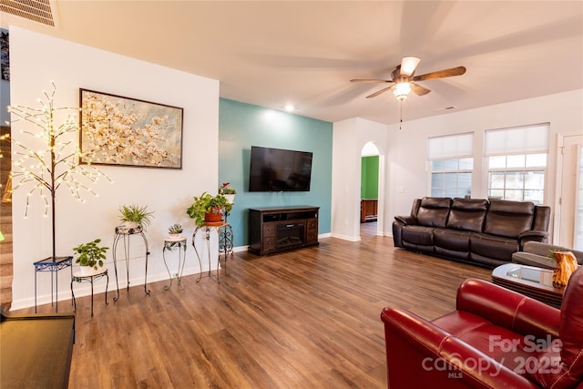 living room with ceiling fan and wood-type flooring