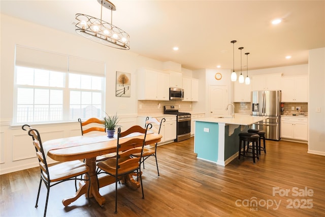 dining room featuring sink and dark wood-type flooring