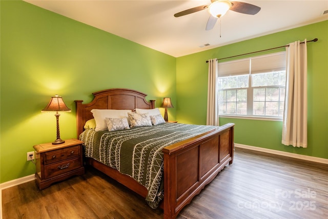 bedroom featuring ceiling fan and dark wood-type flooring