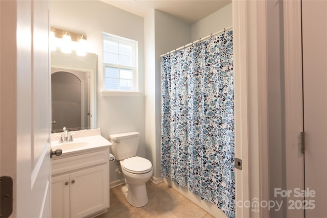 bathroom with toilet, tile patterned floors, and vanity