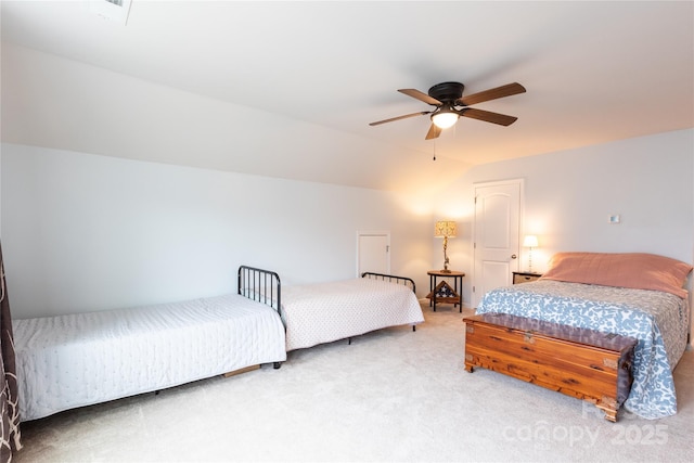 carpeted bedroom with ceiling fan and vaulted ceiling