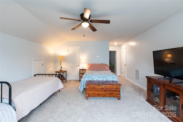 bedroom with ceiling fan, light colored carpet, and lofted ceiling