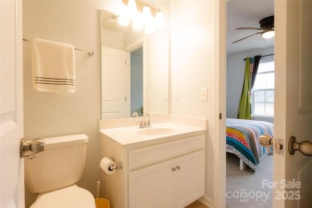 bathroom featuring vanity, toilet, and ceiling fan