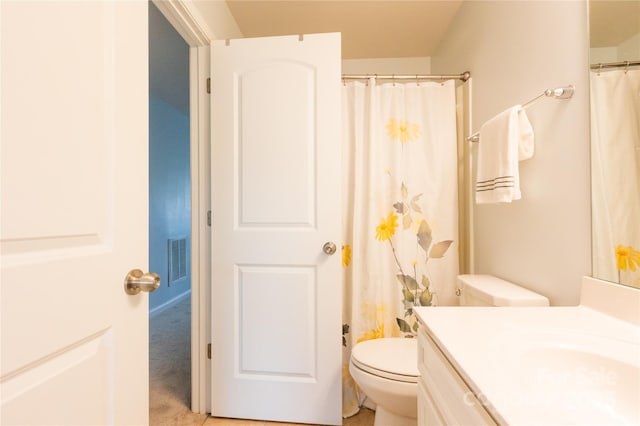 bathroom with toilet and vanity