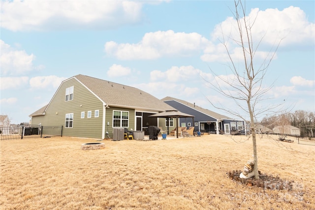 rear view of property with a gazebo, a fire pit, and cooling unit