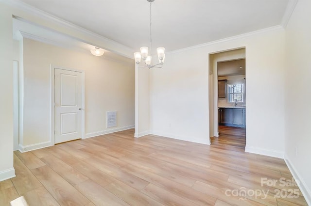 unfurnished dining area featuring sink, light hardwood / wood-style flooring, an inviting chandelier, and crown molding