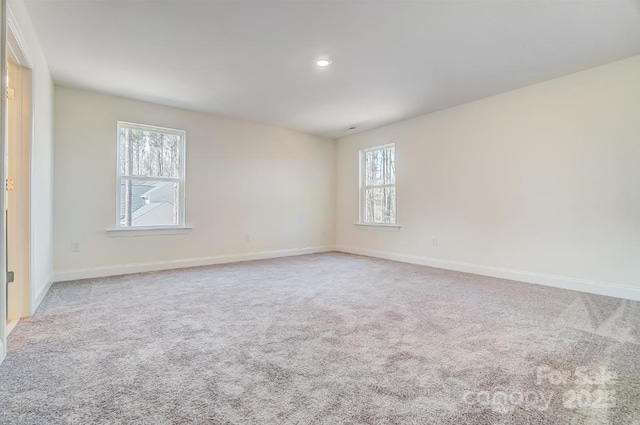 carpeted empty room featuring plenty of natural light