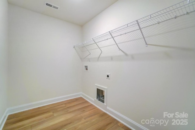 laundry room with washer hookup, wood-type flooring, and electric dryer hookup