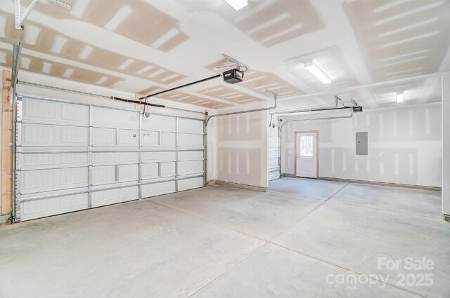 garage with electric panel and a garage door opener