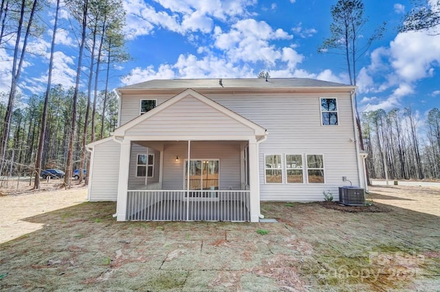 back of property with a porch and central air condition unit