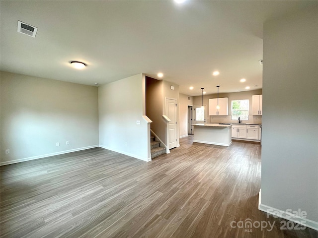 129 Sharon Rd, York, SC 29745 - unfurnished living room featuring baseboards, visible vents, stairway, and dark wood-type flooring