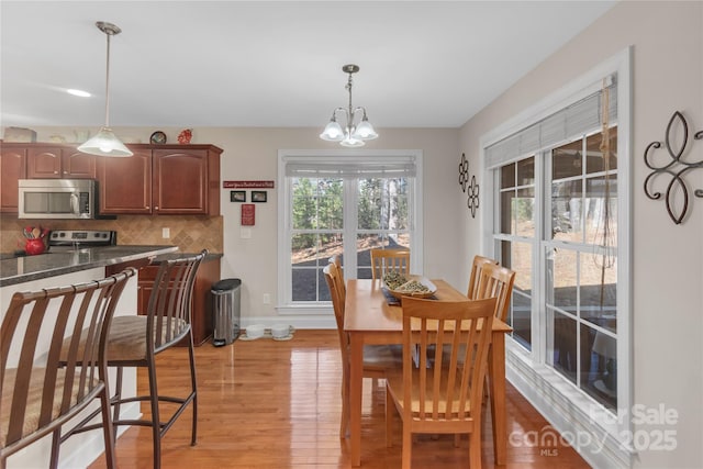 dining room featuring an inviting chandelier and light hardwood / wood-style flooring