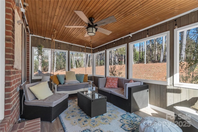 sunroom with wooden ceiling and ceiling fan