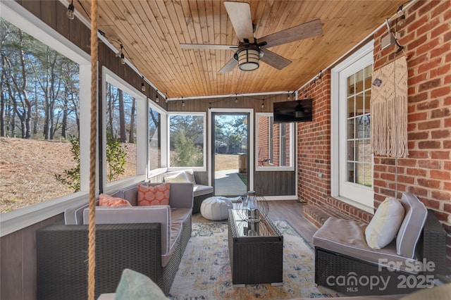 sunroom / solarium with ceiling fan and wood ceiling