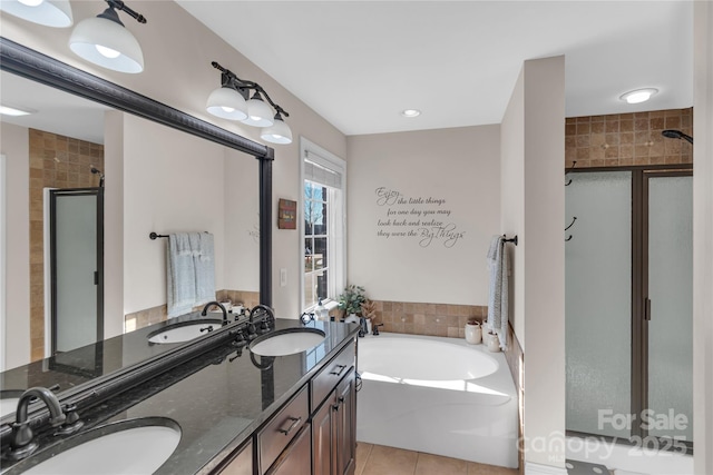 bathroom featuring plus walk in shower, tile walls, tile patterned floors, and vanity