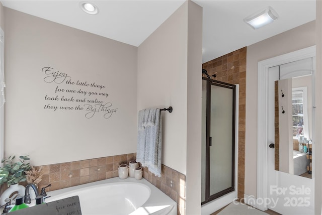 bathroom with separate shower and tub