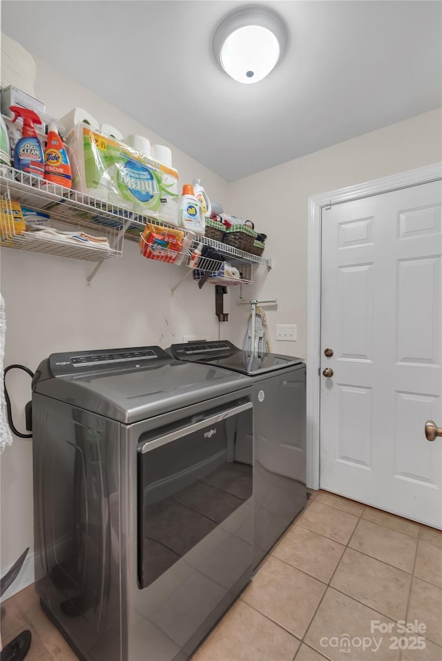 laundry room featuring light tile patterned floors and washer and dryer