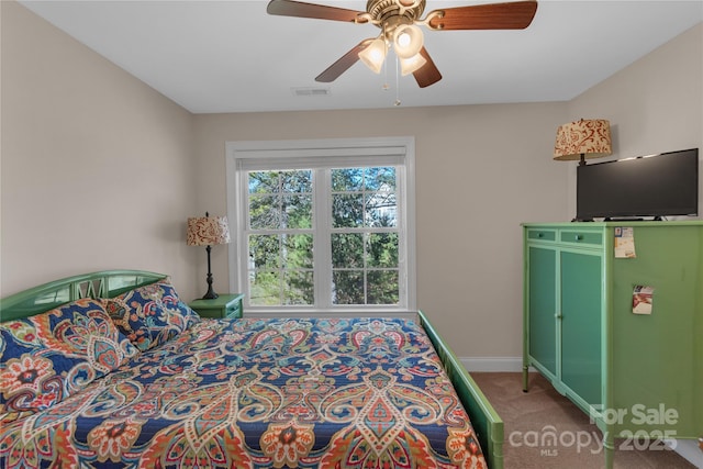 bedroom featuring ceiling fan and carpet