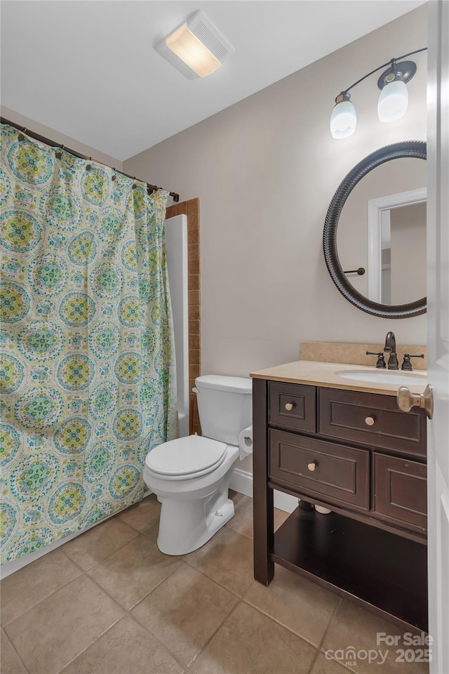 full bathroom featuring shower / bath combo with shower curtain, tile patterned floors, toilet, and vanity