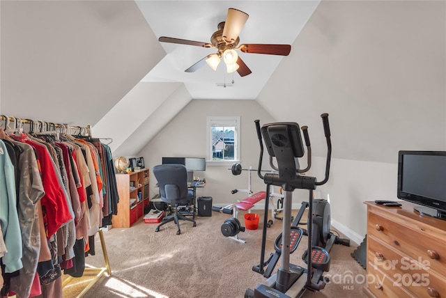 workout area featuring light carpet, ceiling fan, and vaulted ceiling