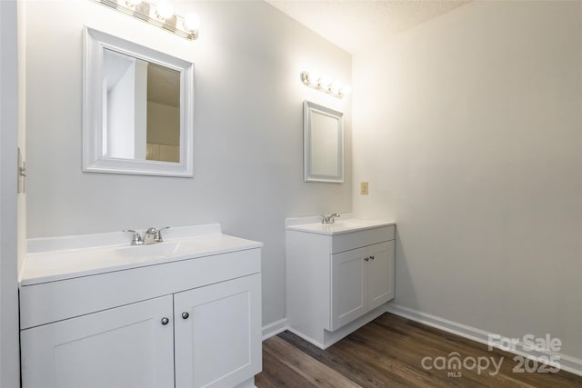 bathroom with vanity, hardwood / wood-style floors, and a textured ceiling