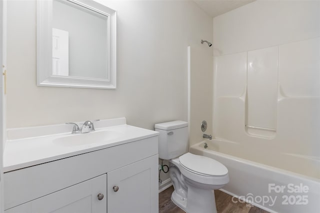 full bathroom with vanity, toilet, bathing tub / shower combination, and hardwood / wood-style floors