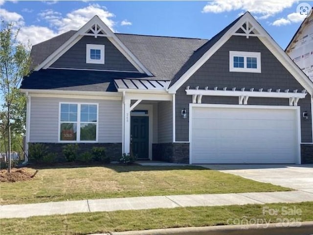 craftsman inspired home with a garage and a front yard