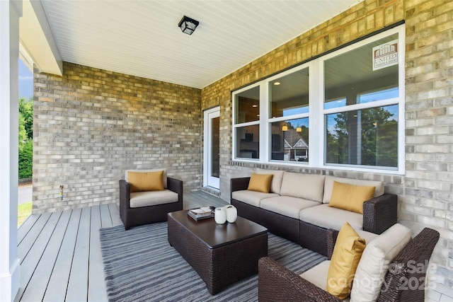 wooden terrace featuring outdoor lounge area