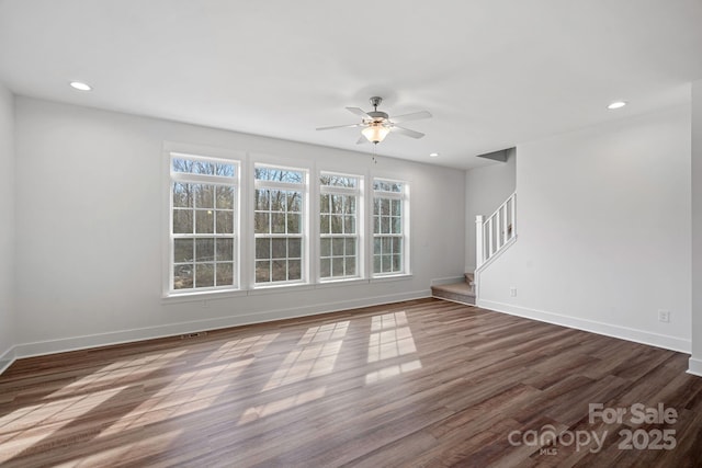 unfurnished living room with dark wood-type flooring and ceiling fan