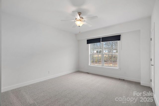 spare room featuring ceiling fan and light colored carpet