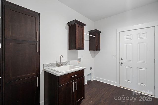 clothes washing area with sink, cabinets, washer hookup, dark wood-type flooring, and hookup for an electric dryer