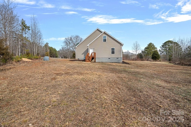 view of side of home featuring a lawn