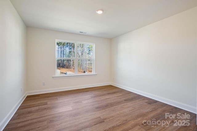 spare room with wood-type flooring