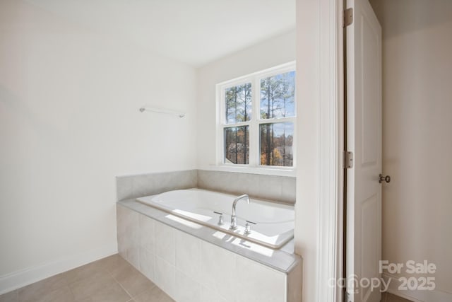 bathroom with tiled tub and tile patterned flooring