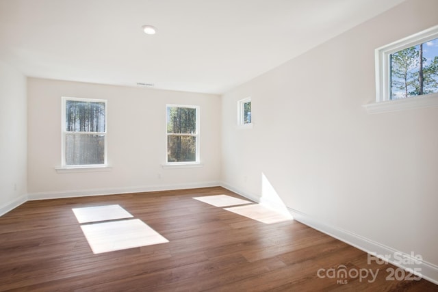 unfurnished room featuring dark hardwood / wood-style flooring