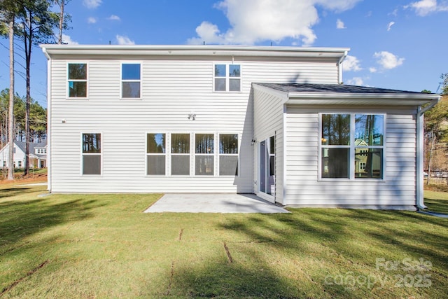 rear view of house with a patio and a yard