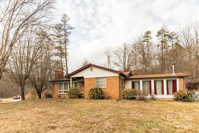 ranch-style home with a front lawn