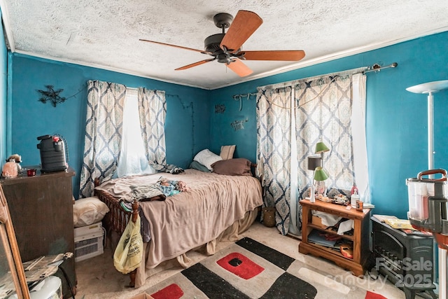 bedroom with a textured ceiling, light colored carpet, and ceiling fan