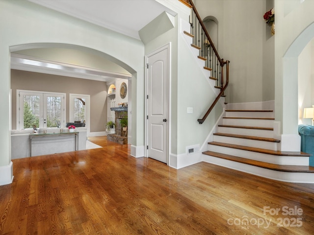 staircase featuring hardwood / wood-style floors and french doors