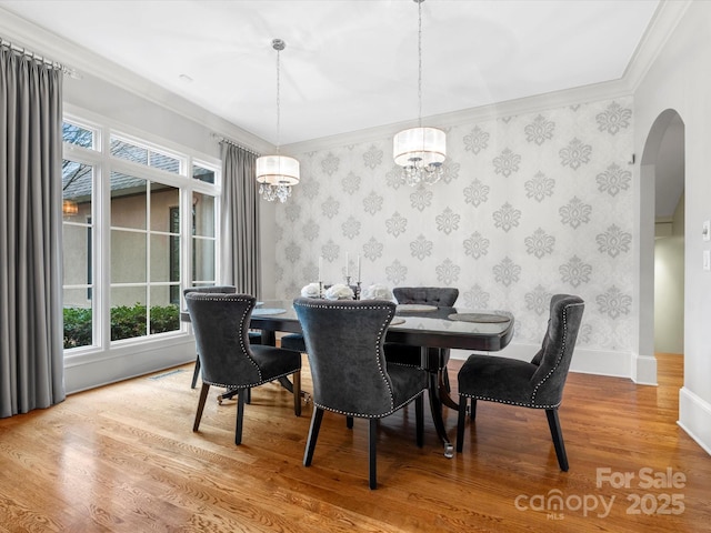 dining room with ornamental molding and hardwood / wood-style floors