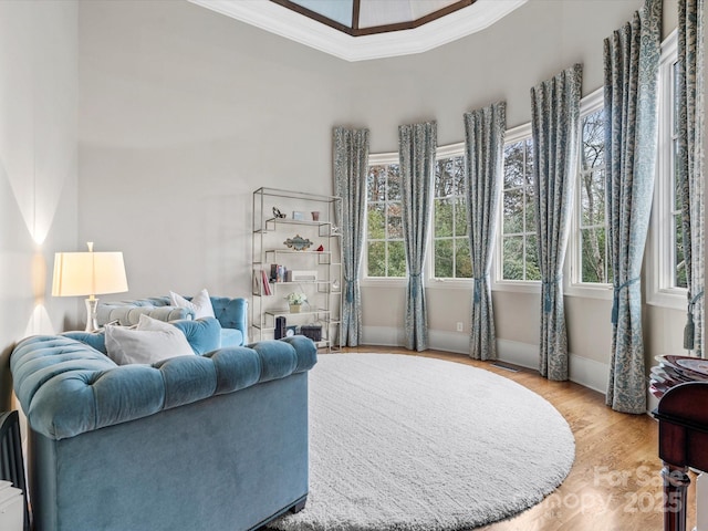 living room with light hardwood / wood-style flooring and crown molding